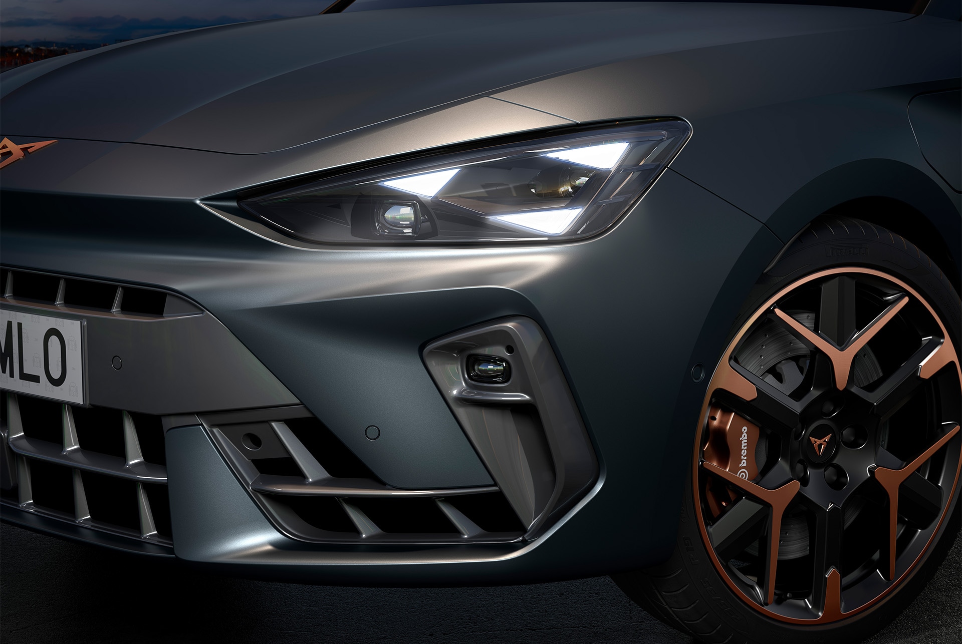 Primer pla del nou cotxe híbrid Cupra Leon 2025, fars i llandes forjades de 48cm (19") amb acabat Hailstorm Copper i carrosseria grisa Enceladus mat.
